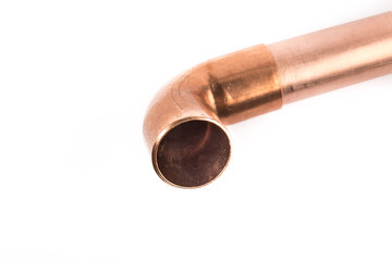 extreme macro closeup of a copper plumbing elbow on a copper pipe isolated on white