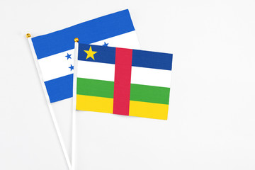 Central African Republic and Honduras stick flags on white background. High quality fabric,...