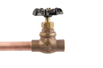 a brass plumbing shut off valve attached to a copper pipe