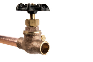 extreme macro closeup of a brass plumbing valve on a copper pipe isolated on white