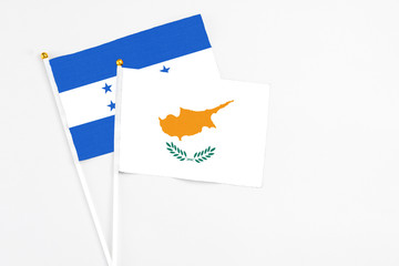 Cyprus and Honduras stick flags on white background. High quality fabric, miniature national flag....