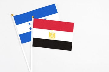 Egypt and Honduras stick flags on white background. High quality fabric, miniature national flag....