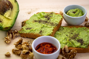 toasted bread with avocado ,red hot chilli,nuts and pepper 