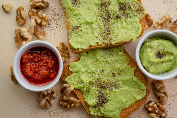 toasted bread with avocado ,red hot chilli,nuts and pepper 