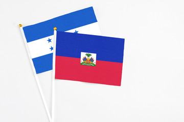 Haiti and Honduras stick flags on white background. High quality fabric, miniature national flag....