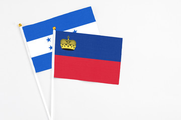 Liechtenstein and Honduras stick flags on white background. High quality fabric, miniature national...