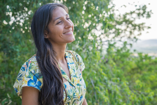 Young indian woman laughing in the countryside