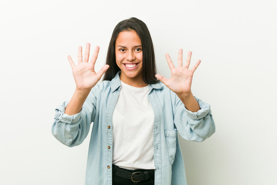 Young hispanic woman showing number ten with hands.