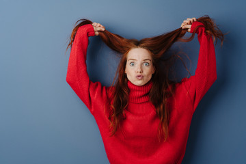 Temperamental young woman pulling her hair
