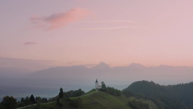 Sunrise over Jamnik, Slovenia. Aerial drone view over Alps and Church St. Primoz