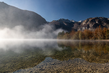 Foggy lake Bohinj in the Triglav national park at sunrise