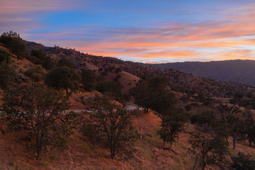Southern California landscape at twilight including a road and beautiful sky.