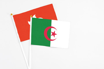 Algeria and Hong Kong stick flags on white background. High quality fabric, miniature national...