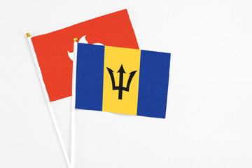 Barbados and Hong Kong stick flags on white background. High quality fabric, miniature national flag. Peaceful global concept.White floor for copy space.