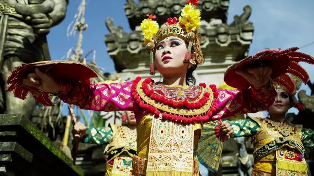 Balinese females dancing by sacred Hindu temple Ubud