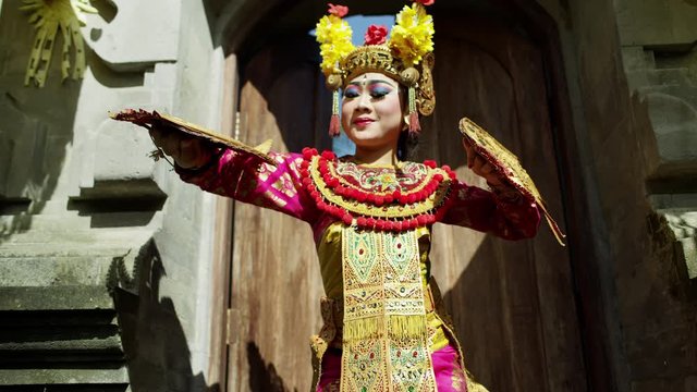 Artistic females performing near ancient religious temple Indonesia