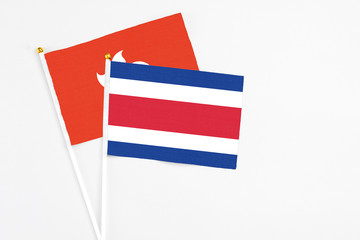 Costa Rica and Hong Kong stick flags on white background. High quality fabric, miniature national flag. Peaceful global concept.White floor for copy space.