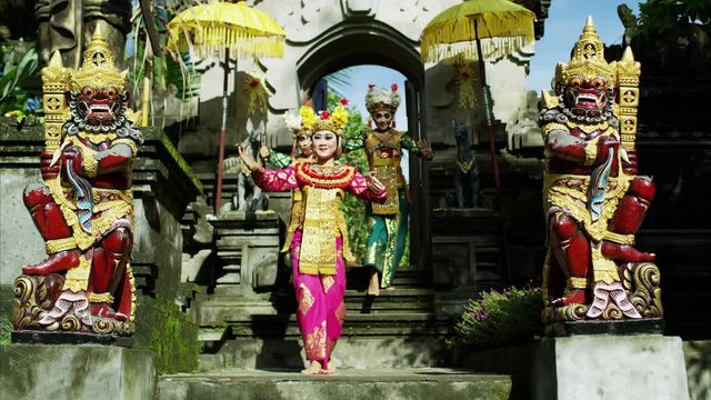 Artistic females performing near ancient religious temple Indonesia