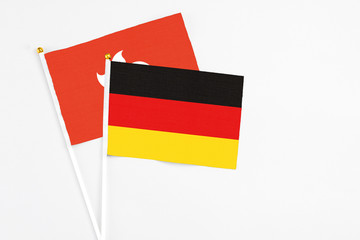 Germany and Hong Kong stick flags on white background. High quality fabric, miniature national flag. Peaceful global concept.White floor for copy space.