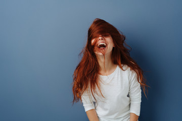 Vivacious young woman enjoying a good belly laugh