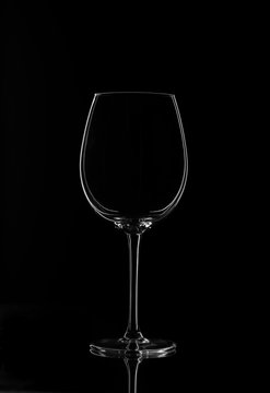 Empty wine glass isolated on a dark background