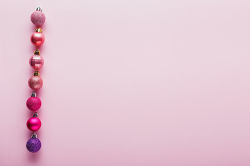 A lot of Christmas balls of coral color.