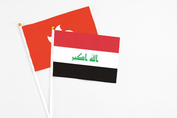 Iraq and Hong Kong stick flags on white background. High quality fabric, miniature national flag. Peaceful global concept.White floor for copy space.