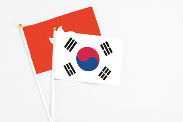 South Korea and Hong Kong stick flags on white background. High quality fabric, miniature national flag. Peaceful global concept.White floor for copy space.