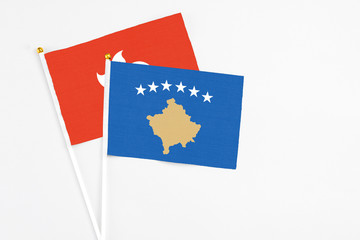 Kosovo and Hong Kong stick flags on white background. High quality fabric, miniature national flag. Peaceful global concept.White floor for copy space.