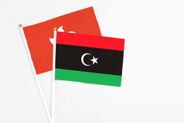 Libya and Hong Kong stick flags on white background. High quality fabric, miniature national flag. Peaceful global concept.White floor for copy space.