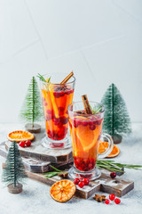 Orange and cranberry drinks with orange slices and spices. Hot drinks for winter and Christmas