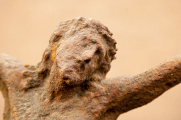 Destroyed ancient iron statue of crucifixion of Jesus Christ as a symbol of human soul eternal life