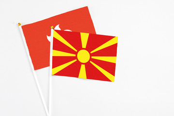 Macedonia and Hong Kong stick flags on white background. High quality fabric, miniature national flag. Peaceful global concept.White floor for copy space.