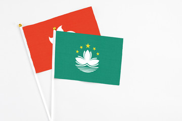 Macao and Hong Kong stick flags on white background. High quality fabric, miniature national flag. Peaceful global concept.White floor for copy space.