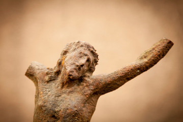 Destroyed ancient iron statue of crucifixion of Jesus Christ as a symbol of human soul eternal life