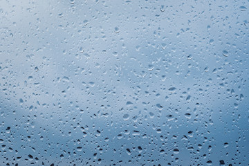 Raindrops on window glass surface, background texture