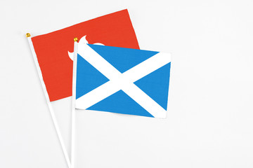 Scotland and Hong Kong stick flags on white background. High quality fabric, miniature national flag. Peaceful global concept.White floor for copy space.