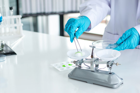 Researchers are weighing tablets in the laboratory.