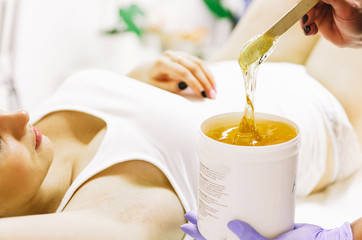 woman doing hot sugar wax hair removal