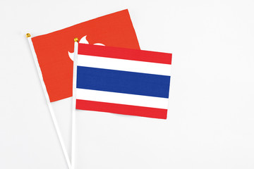 Thailand and Hong Kong stick flags on white background. High quality fabric, miniature national flag. Peaceful global concept.White floor for copy space.