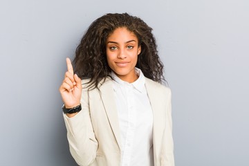 Young african american business woman showing number one with finger.
