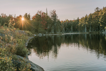 Kayaking in Boreas Ponds in the Adirondacks on a glassy lake with Mount Marcy and the high peaks in...