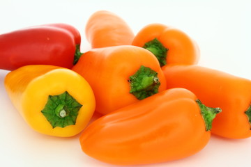 Fresh peppers - close-up - orange, yellow, red vegetables on white background