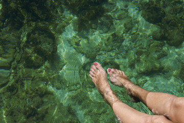 Female legs in the water