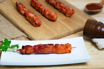 Pinchos morunos  or meat skewer. Typical Spanish cuisine dish made with pork or chicken carn marinated with garlic and paprika