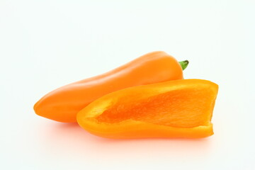 Sliced orange sweet pepper on white background - cross-section - fresh food