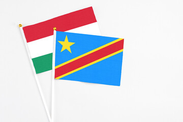 Congo and Hungary stick flags on white background. High quality fabric, miniature national flag. Peaceful global concept.White floor for copy space.