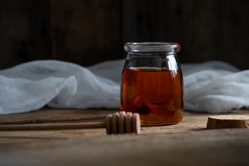 honey cake. jar of honey. hand with a spoon for honey. honey drips from a spoon