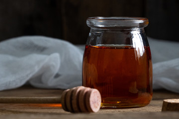 honey cake. jar of honey. hand with a spoon for honey. honey drips from a spoon