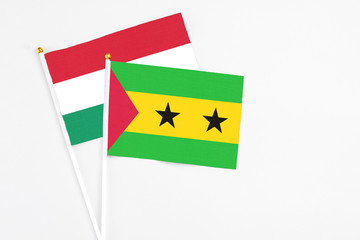 Sao Tome And Principe and Hungary stick flags on white background. High quality fabric, miniature national flag. Peaceful global concept.White floor for copy space.